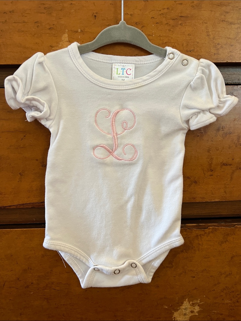 White Baby One-Piece with Pink Monogram L